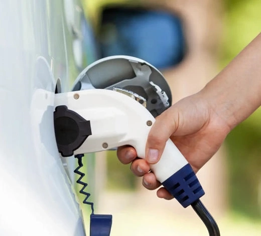 holding an EV charging gun